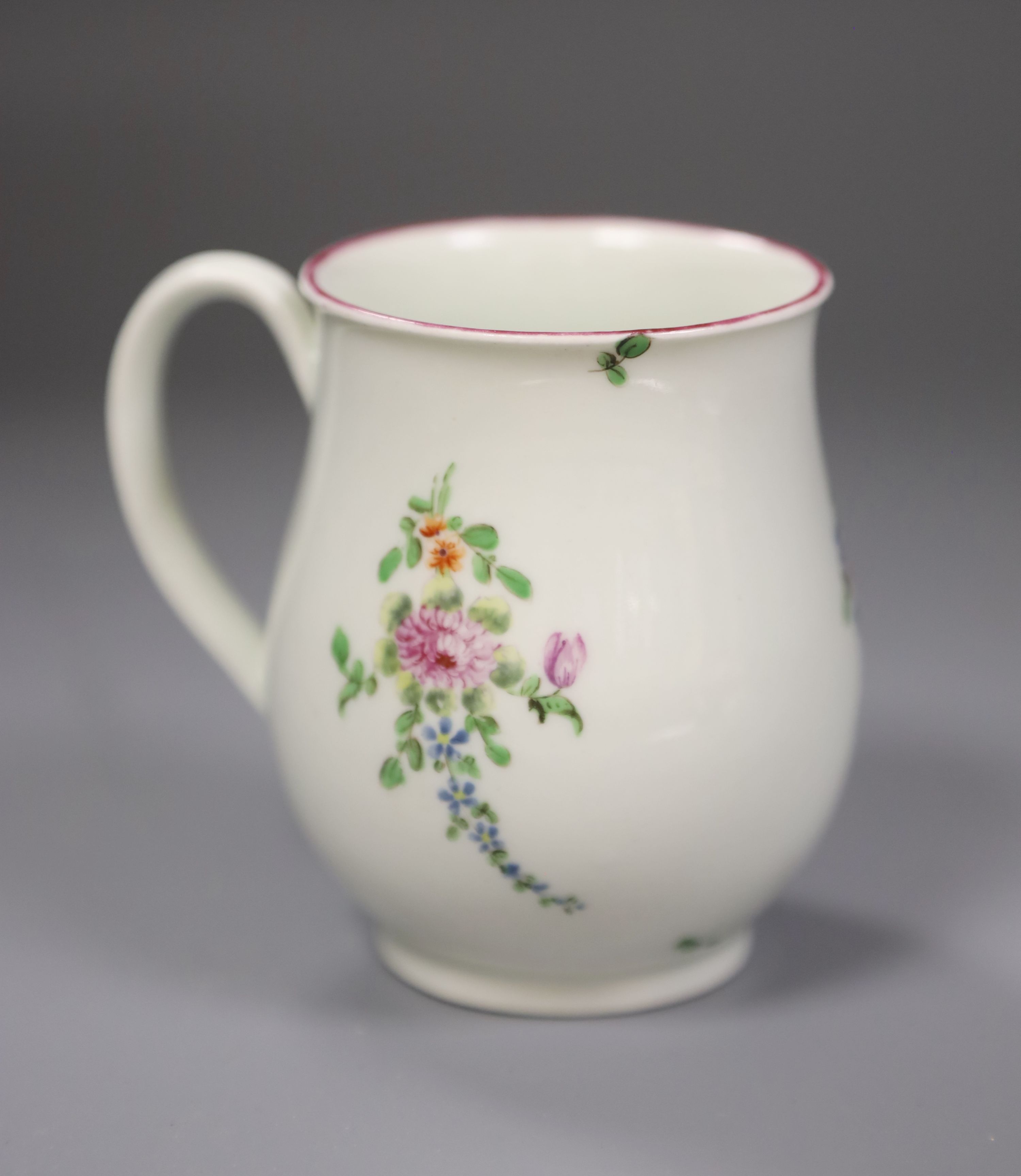 A Worcester bell shape mug painted with scattered coloured flowers, height 9cm